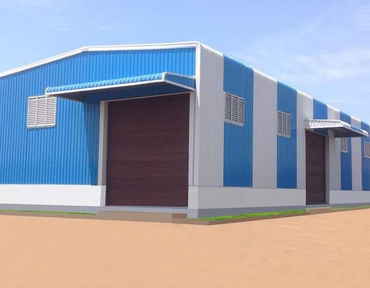 Blue and white industrial shed with motorized rolling shutters