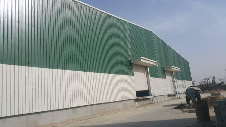 Green and white corrugated metal sheet cladding wall