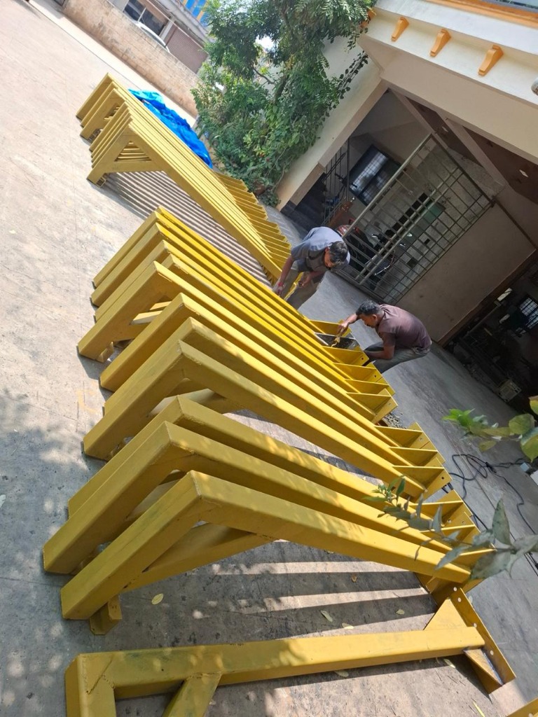 Workers Fabricating Yellow Steel Structures Outdoors